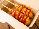 Corn dog with mustard and ketchup